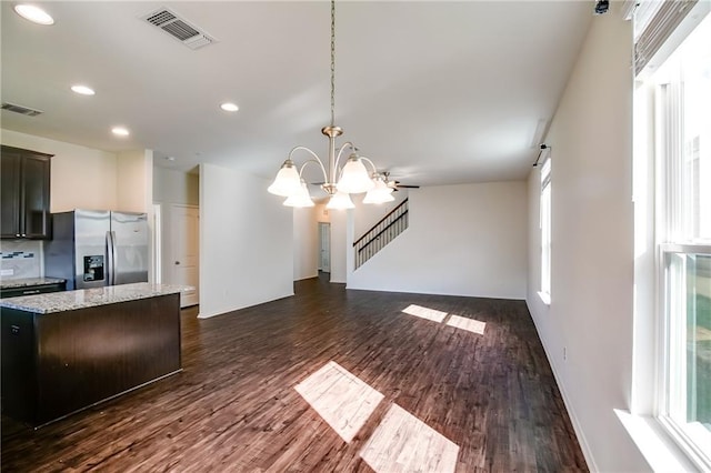253 Beechnut Dr, Buda, TX 78610 - unfurnished living room with a chandelier, healthy amount of natural light, dark wood finished floors, recessed lighting, and a barn door