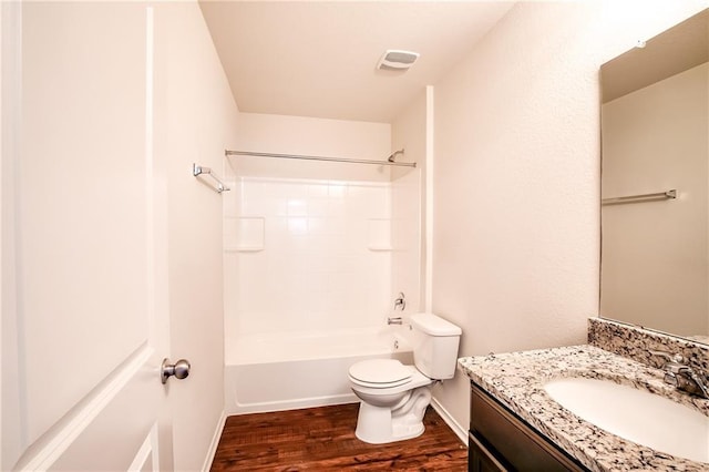 253 Beechnut Dr, Buda, TX 78610 - full bath featuring wood finished floors, toilet, vanity, baseboards, and shower / washtub combination