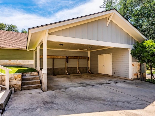 garage featuring driveway and an attached carport