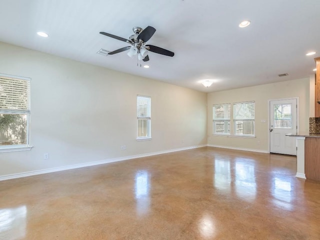 empty room featuring finished concrete floors, baseboards, ceiling fan, and recessed lighting