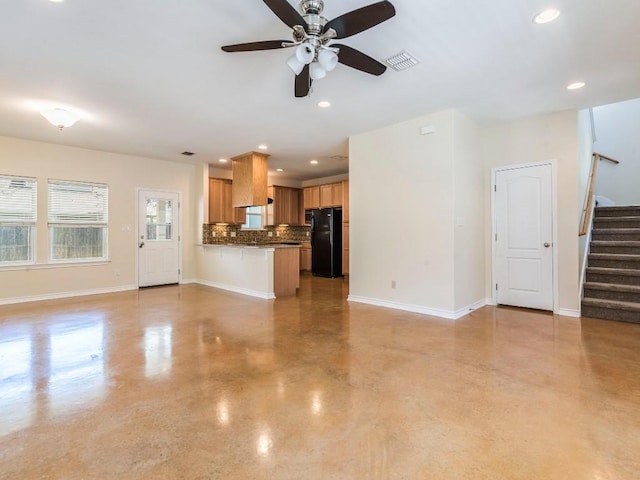 unfurnished living room with stairs, ceiling fan, baseboards, finished concrete floors, and recessed lighting