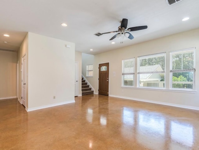 unfurnished living room featuring baseboards, concrete floors, stairway, recessed lighting, and ceiling fan