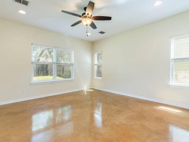 unfurnished room with finished concrete flooring, ceiling fan, baseboards, and recessed lighting