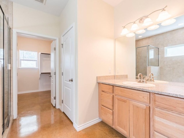 full bath with tiled shower, healthy amount of natural light, a spacious closet, and concrete flooring