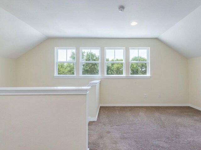 bonus room with lofted ceiling, healthy amount of natural light, baseboards, carpet flooring, and recessed lighting