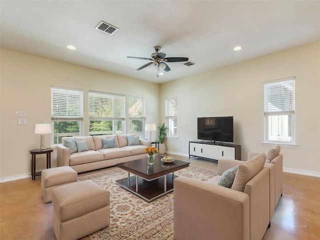 living area featuring baseboards, ceiling fan, and recessed lighting