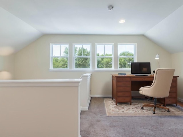 office space with vaulted ceiling, healthy amount of natural light, carpet, and baseboards
