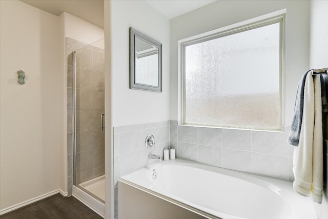 216 Xanadu Dr, Jarrell, TX 76537 - bathroom with a stall shower, a bath, and wood finished floors