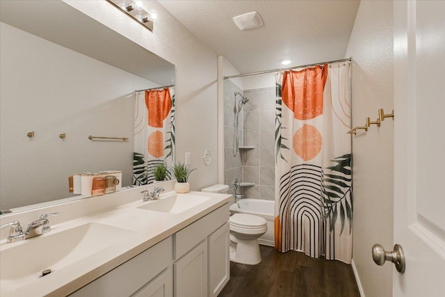 216 Xanadu Dr, Jarrell, TX 76537 - bathroom featuring wood finished floors, toilet, double vanity, and shower / bath combo