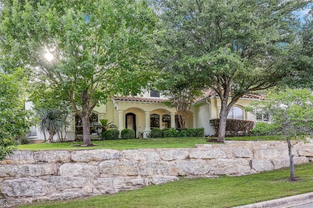 2116 Demona Dr, Austin, TX 78733 - mediterranean / spanish-style home featuring stucco siding, a front lawn, and a tile roof