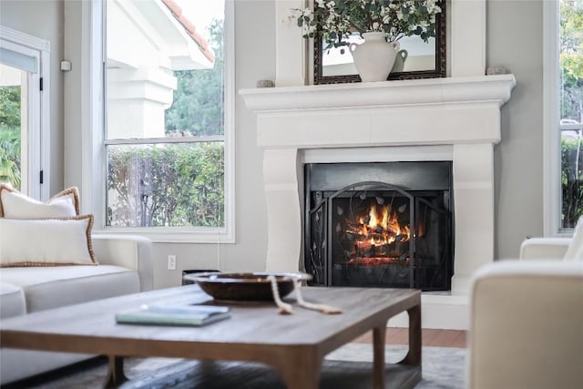 2116 Demona Dr, Austin, TX 78733 - living area with a warm lit fireplace, healthy amount of natural light, and wood finished floors