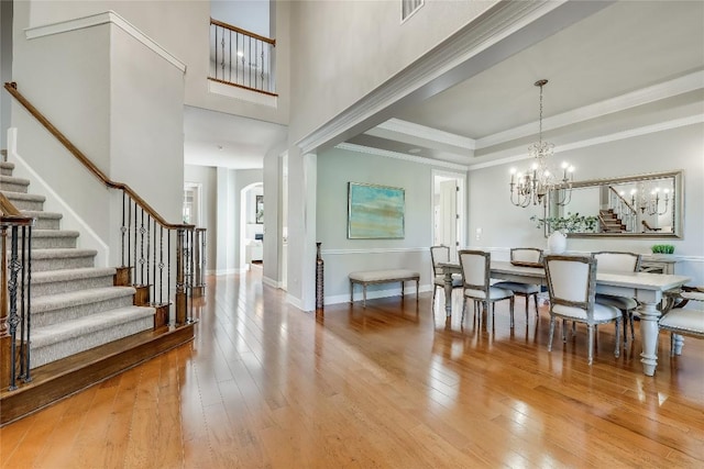 2116 Demona Dr, Austin, TX 78733 - foyer entrance with stairs, hardwood / wood-style floors, a chandelier, and arched walkways