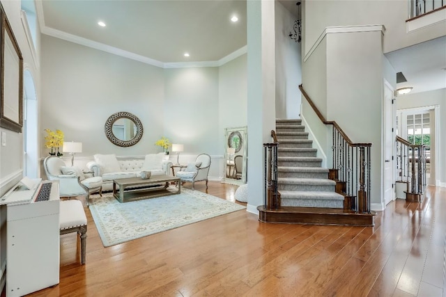 2116 Demona Dr, Austin, TX 78733 - living area featuring stairway, a towering ceiling, wood finished floors, crown molding, and recessed lighting
