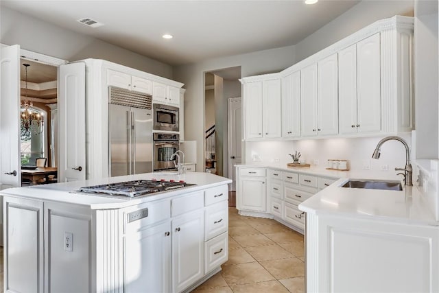2116 Demona Dr, Austin, TX 78733 - kitchen with built in appliances, recessed lighting, white cabinetry, light countertops, and light tile patterned floors