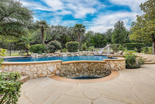 2116 Demona Dr, Austin, TX 78733 - view of swimming pool with a water slide, fence, a patio area, and view of scattered trees