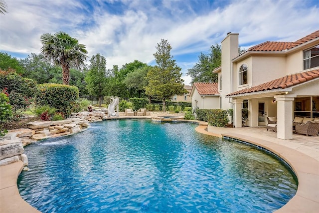 2116 Demona Dr, Austin, TX 78733 - view of pool with a patio area, a water slide, an outdoor hangout area, and a pool with connected hot tub
