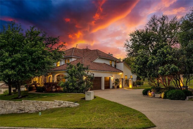 2116 Demona Dr, Austin, TX 78733 - mediterranean / spanish-style home featuring a garage, driveway, stucco siding, and a tiled roof