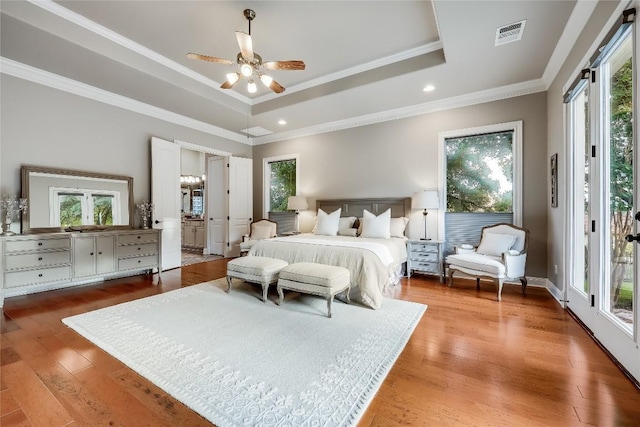 2116 Demona Dr, Austin, TX 78733 - bedroom featuring a tray ceiling, access to outside, multiple windows, ornamental molding, and recessed lighting