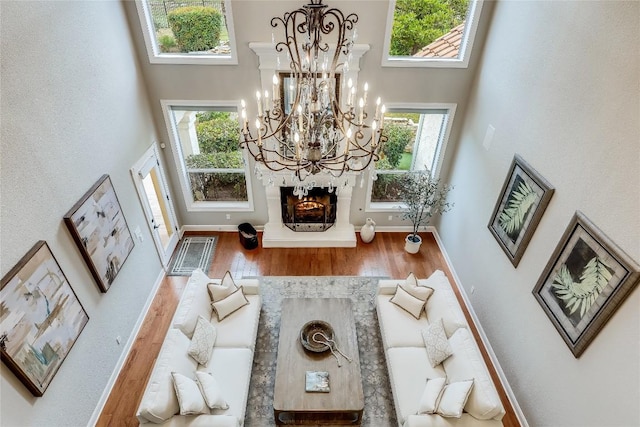 2116 Demona Dr, Austin, TX 78733 - living area featuring a high ceiling, wood finished floors, and a chandelier