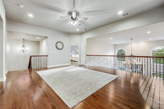 2116 Demona Dr, Austin, TX 78733 - spare room with a chandelier, a ceiling fan, wood-type flooring, baseboards, and recessed lighting
