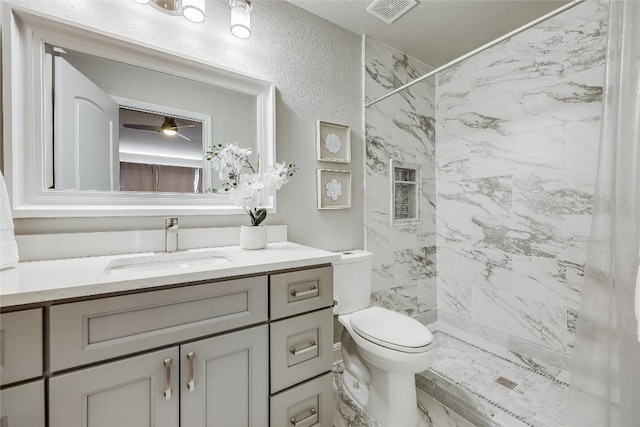 2116 Demona Dr, Austin, TX 78733 - bathroom with a tile shower, vanity, and toilet