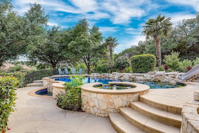 2116 Demona Dr, Austin, TX 78733 - view of swimming pool with a water slide, fence, a pool with connected hot tub, and a patio