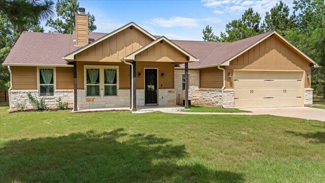 113 N Buckhorn Dr, Bastrop, TX 78602 - craftsman house with board and batten siding, stone siding, and a garage