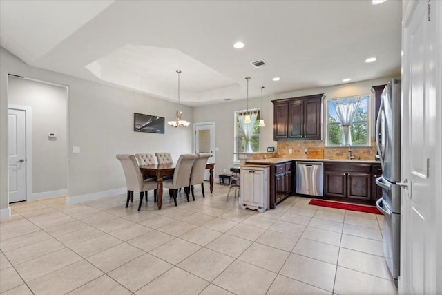 113 N Buckhorn Dr, Bastrop, TX 78602 - kitchen with stainless steel appliances, light tile patterned floors, a chandelier, a peninsula, and recessed lighting