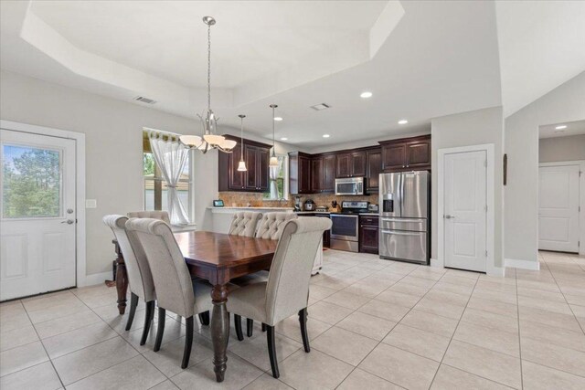 113 N Buckhorn Dr, Bastrop, TX 78602 - dining space with a chandelier, light tile patterned flooring, baseboards, recessed lighting, and a raised ceiling