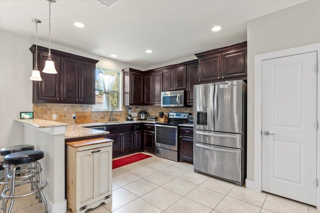 113 N Buckhorn Dr, Bastrop, TX 78602 - kitchen with appliances with stainless steel finishes, a sink, dark brown cabinets, a peninsula, and backsplash