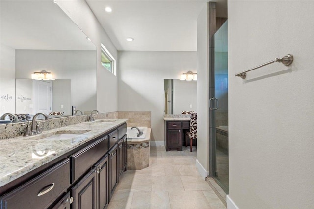 113 N Buckhorn Dr, Bastrop, TX 78602 - full bath with vanity, a garden tub, a shower stall, and recessed lighting