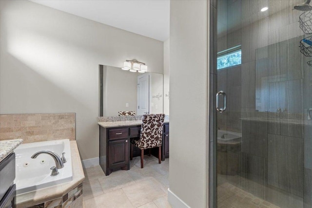 113 N Buckhorn Dr, Bastrop, TX 78602 - bathroom with vanity, a stall shower, a whirlpool tub, tile patterned flooring, and baseboards