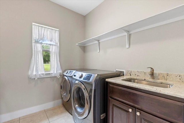 113 N Buckhorn Dr, Bastrop, TX 78602 - laundry area featuring washer and dryer, light tile patterned floors, cabinet space, and baseboards