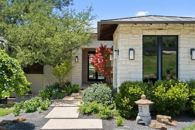 view of exterior entry featuring stone siding