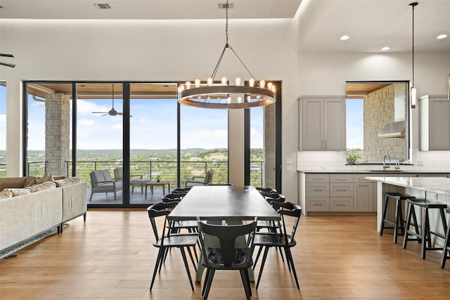 dining room featuring light wood-style floors, a chandelier, and recessed lighting