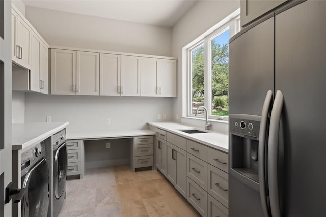 laundry area with a sink and washer and dryer