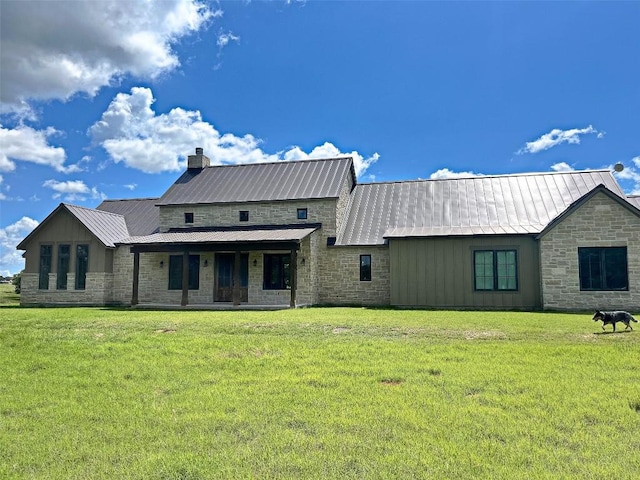 1402 Countryside Bnd, Fredericksburg, TX 78624 - view of front of property featuring stone siding, metal roof, a front lawn, and a chimney