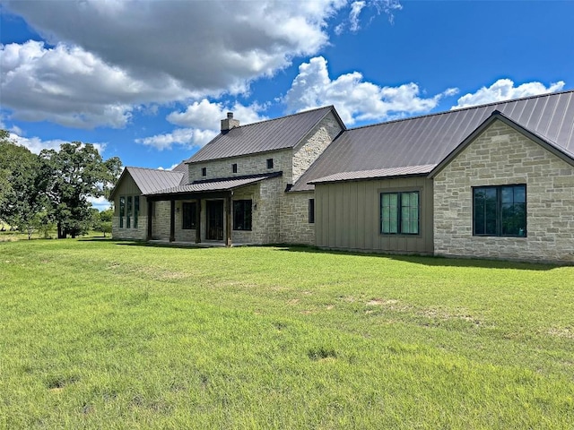 1402 Countryside Bnd, Fredericksburg, TX 78624 - rear view of property featuring stone siding, board and batten siding, a yard, and metal roof