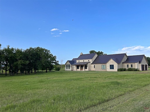 1402 Countryside Bnd, Fredericksburg, TX 78624 - view of front of home featuring a front yard, a standing seam roof, metal roof, and a chimney