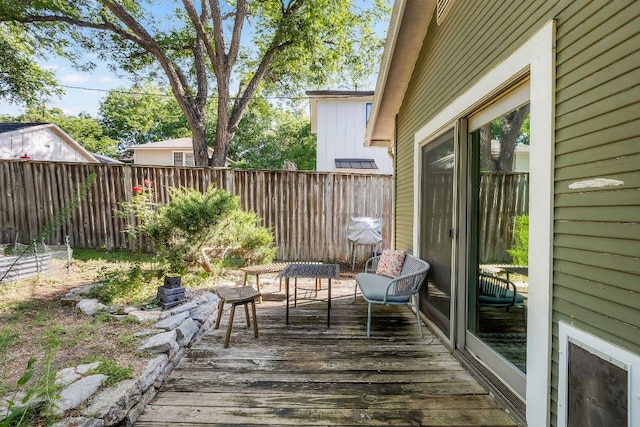 wooden terrace featuring fence