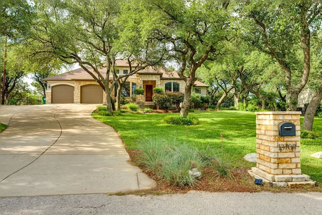 13708 Montview Dr, Austin, TX 78732 - view of front of house with a front lawn, concrete driveway, a garage, and stone siding