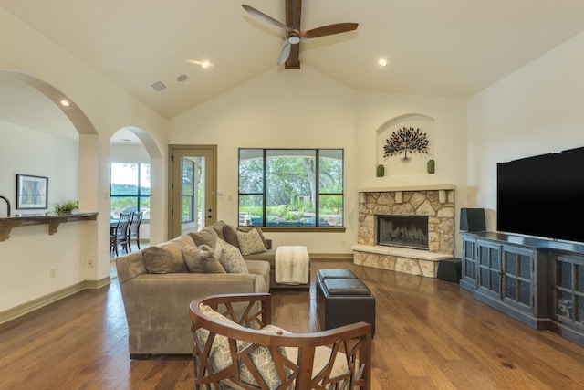 13708 Montview Dr, Austin, TX 78732 - living area with arched walkways, a ceiling fan, wood finished floors, a stone fireplace, and lofted ceiling