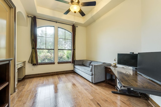 13708 Montview Dr, Austin, TX 78732 - office with ceiling fan, a tray ceiling, light wood-style flooring, and baseboards