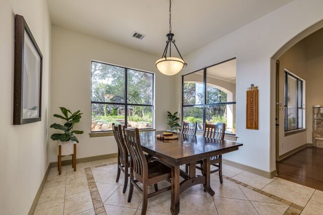 13708 Montview Dr, Austin, TX 78732 - dining space featuring healthy amount of natural light, inlaid floor details, baseboards, and arched walkways