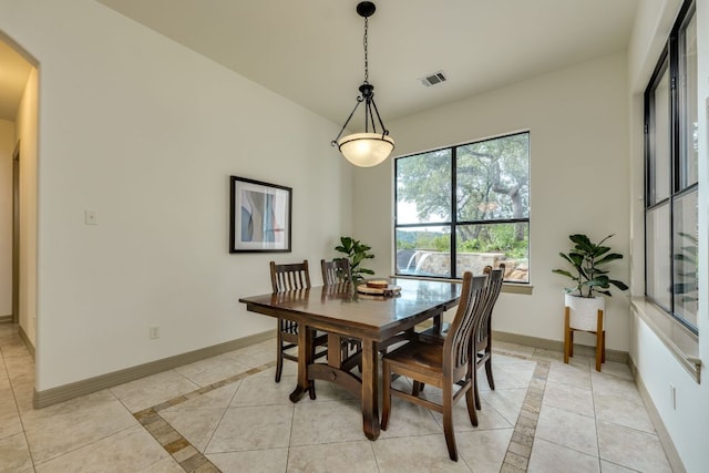 13708 Montview Dr, Austin, TX 78732 - dining room featuring inlaid floor details, arched walkways, baseboards, and light tile patterned floors
