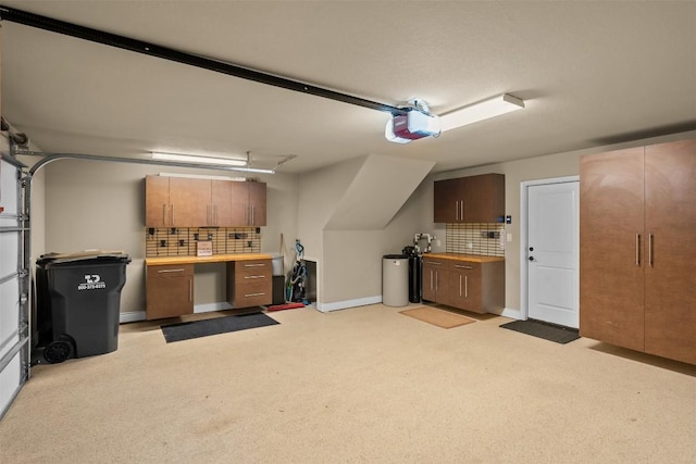 1044 Highknoll Ln, Georgetown, TX 78628 - garage with a garage door opener and baseboards