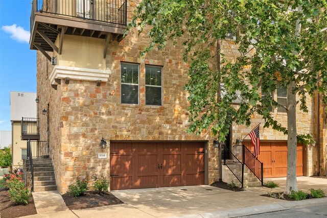 1044 Highknoll Ln, Georgetown, TX 78628 - view of front of house featuring stone siding, a garage, concrete driveway, and stairs