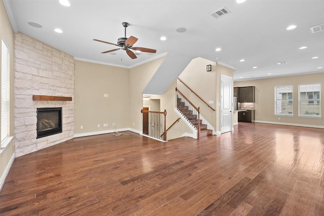1044 Highknoll Ln, Georgetown, TX 78628 - unfurnished living room featuring a ceiling fan, crown molding, wood finished floors, a fireplace, and baseboards