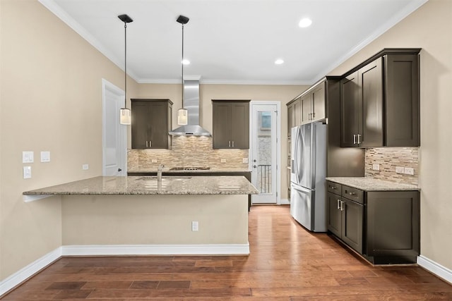 1044 Highknoll Ln, Georgetown, TX 78628 - kitchen with stainless steel fridge with ice dispenser, wall chimney exhaust hood, light stone countertops, backsplash, and crown molding