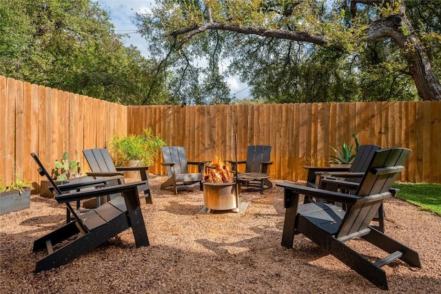 view of patio / terrace featuring an outdoor fire pit and a fenced backyard
